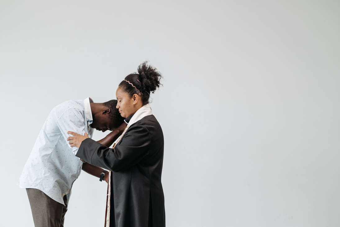 Man Praying with a Pastor